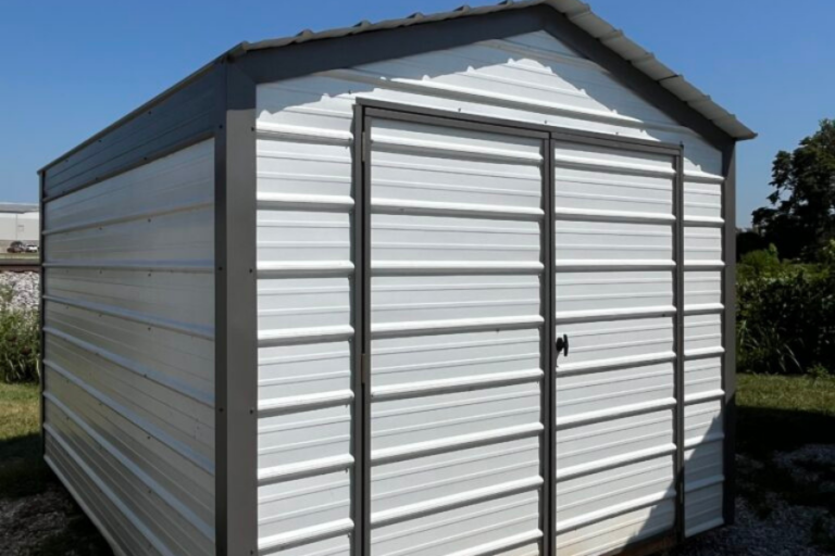 9x12 repo shed with white metal siding and dark trim with double doors