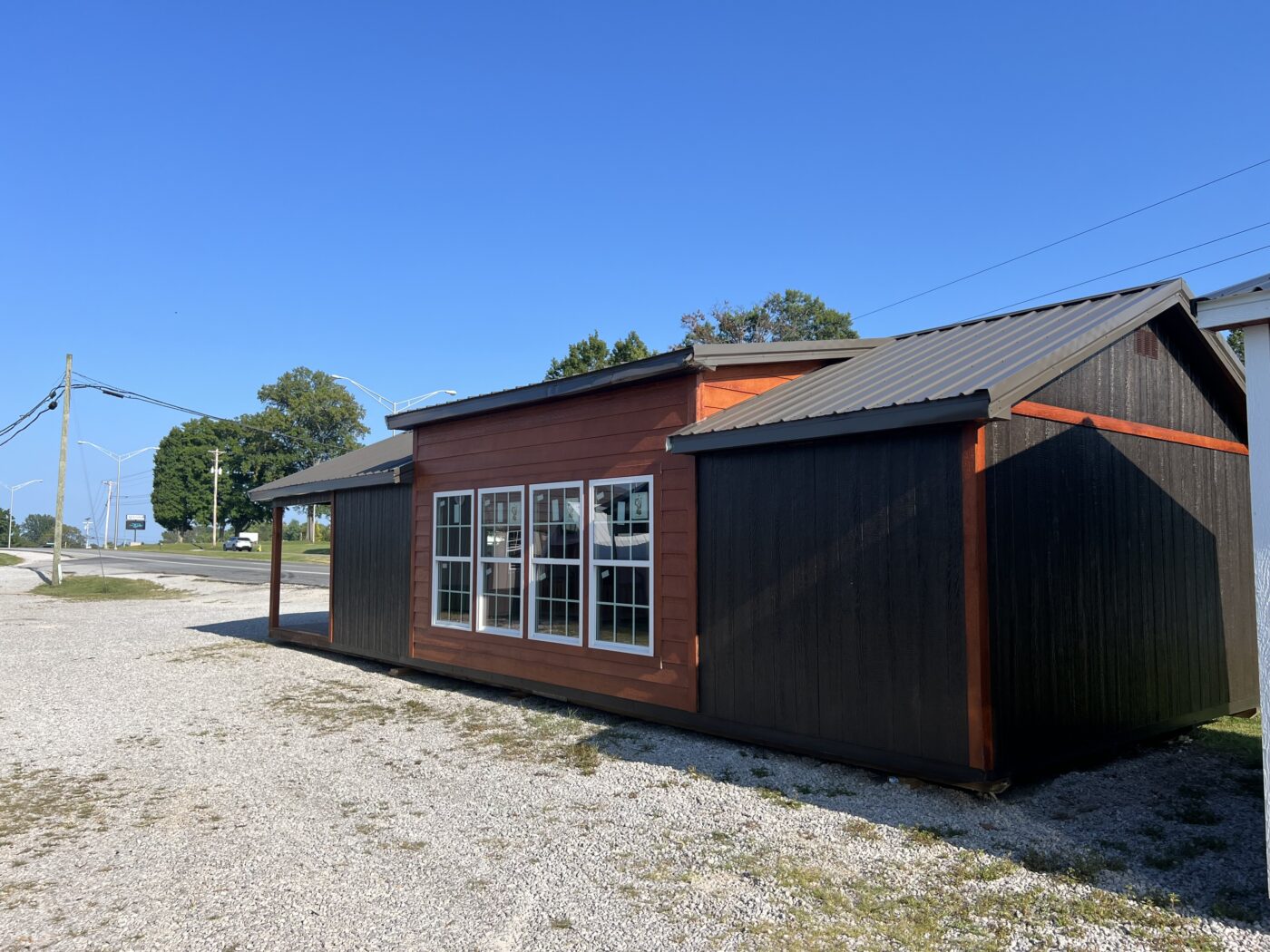 back side of brown and orange 16x40 cabin with four windows