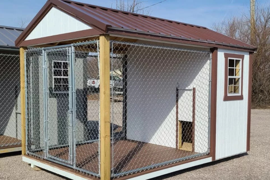 custom white and red trimmed dog kennel with attached run and red metal roof