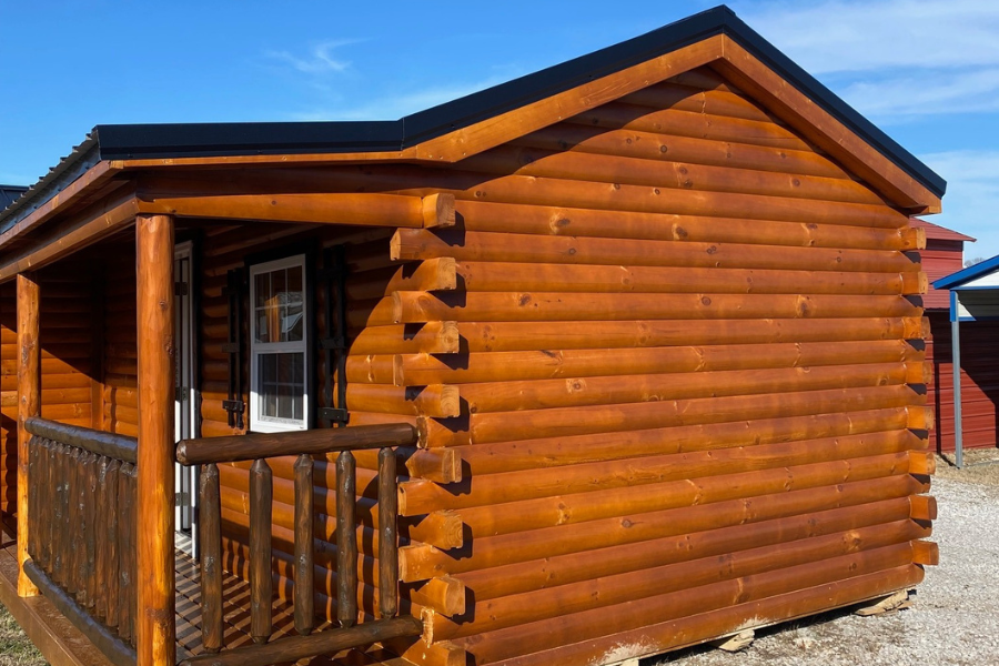 side view of 16x30 log cabin with black metal roof