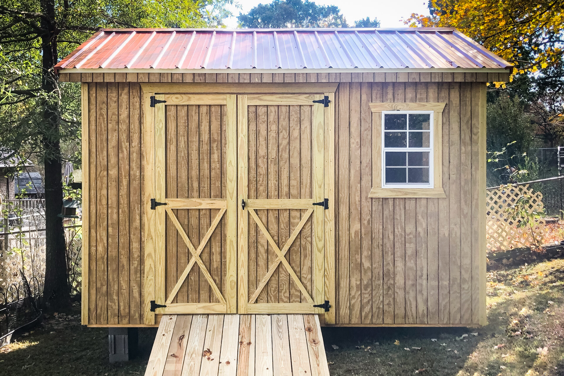 wooden 8x8 utility shed with red roof and ramp